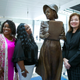 From left, Penny Allison Lockhart and Angela Alice Stephens, great nieces of Alice Allison Dunnigan, stand with sculpture artist Amanda Matthews during the unveiling of Dunnigan’s statue at the Newseum, Friday, Sept. 21, 2018, in Washington. Dunnigan triumphed over sexism and racism to become the first black woman accredited to cover the White House.